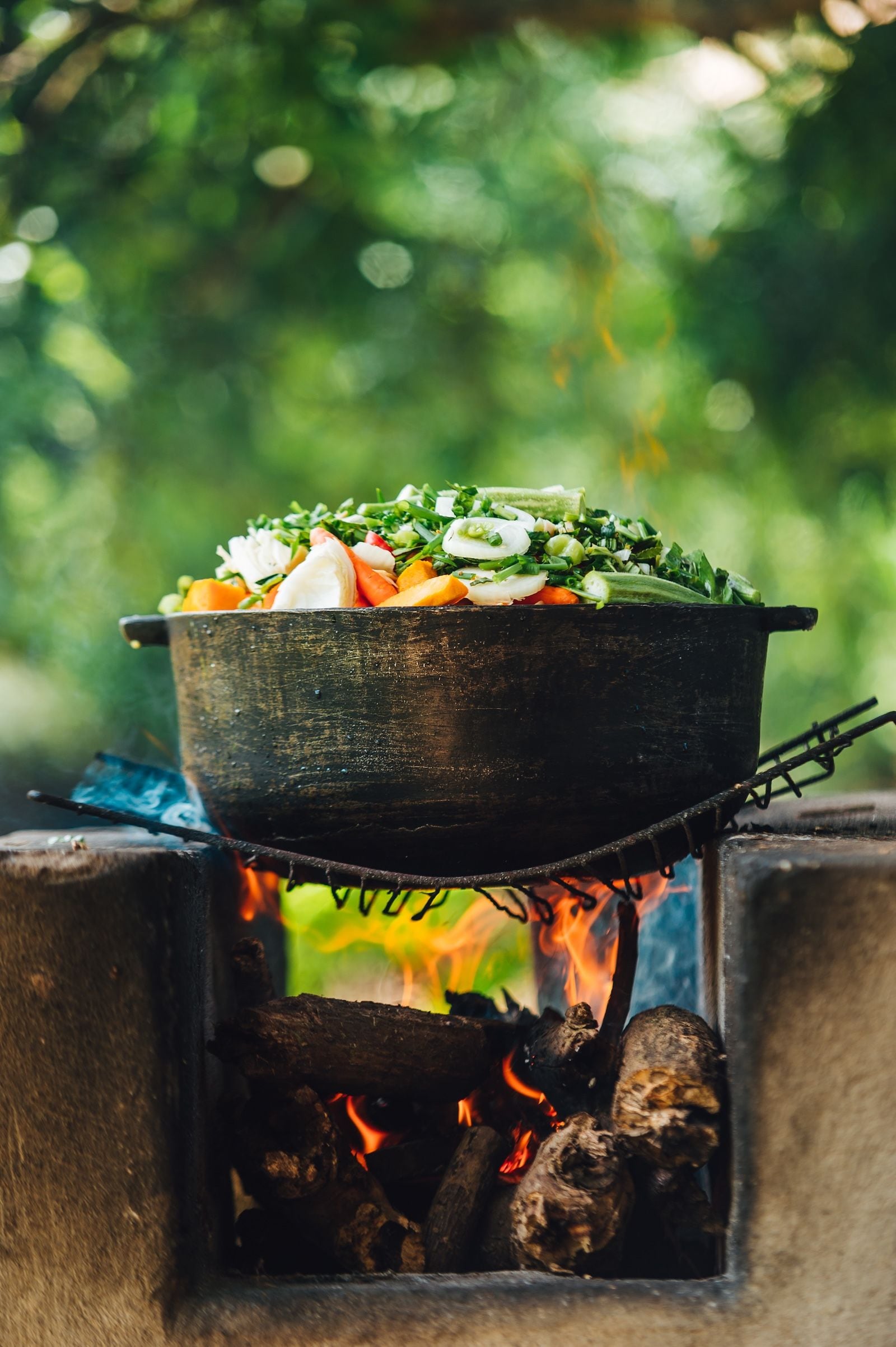 Fresh vegetables cooking over an open fire at T’s EcoGarden