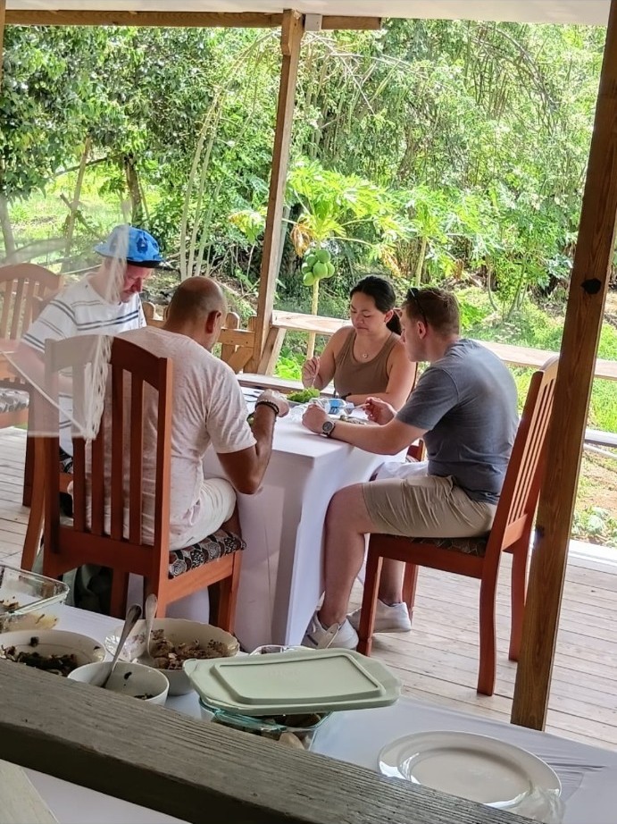 Guests enjoying a farm-to-table meal on the open-air deck