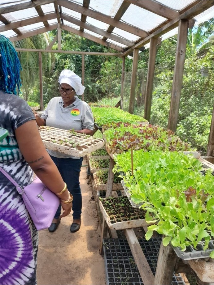 Theresa leading a visitor through the farm nursery